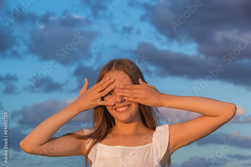 Girl closed his eyes with his hands