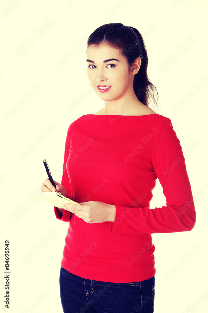 Woman writing notes and planning her schedule Woman writing notes and planning her schedule