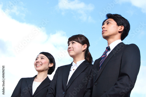 Asian businessman and businesswoman looking up at the sky