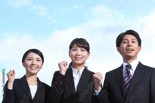 Asian businessman and businesswoman looking up at the sky