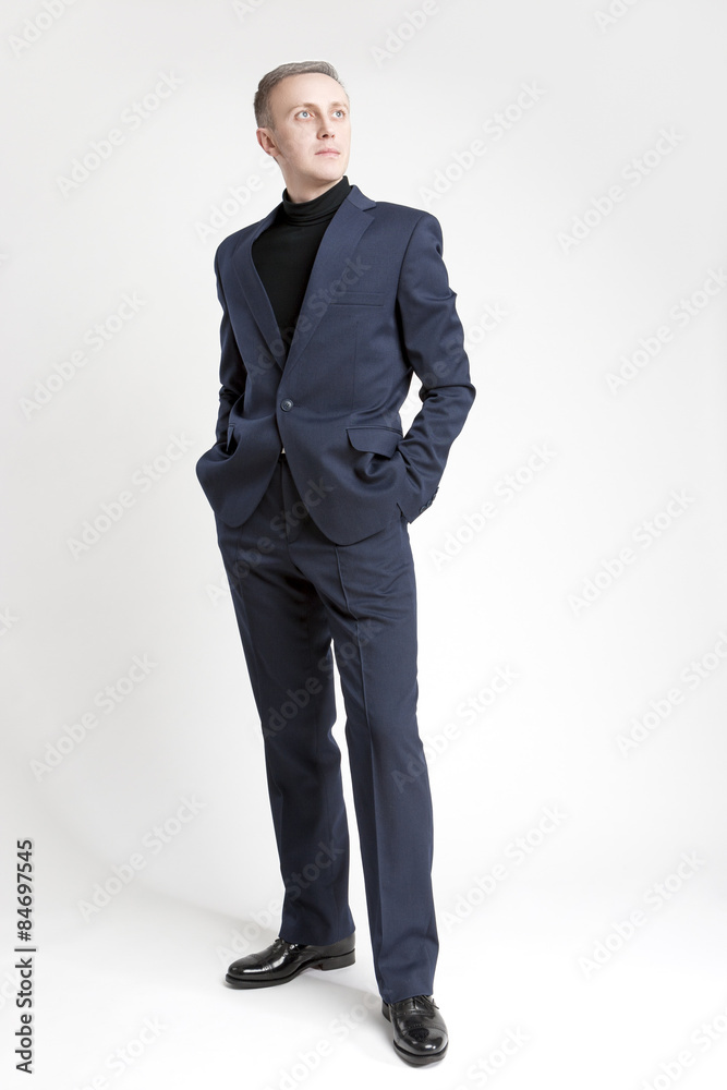 Thinking Stylish Caucasian Man in Made to Order Suit. Posing Aga Thinking Stylish Caucasian Man in Made to Order Suit. Posing Aga