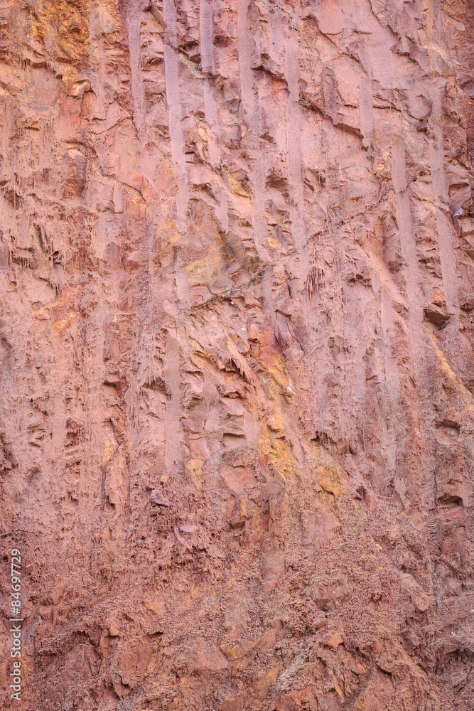 Texture of mountain showing red soil and rock