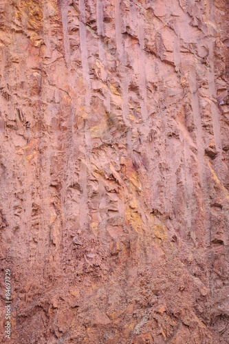 Texture of mountain showing red soil and rock