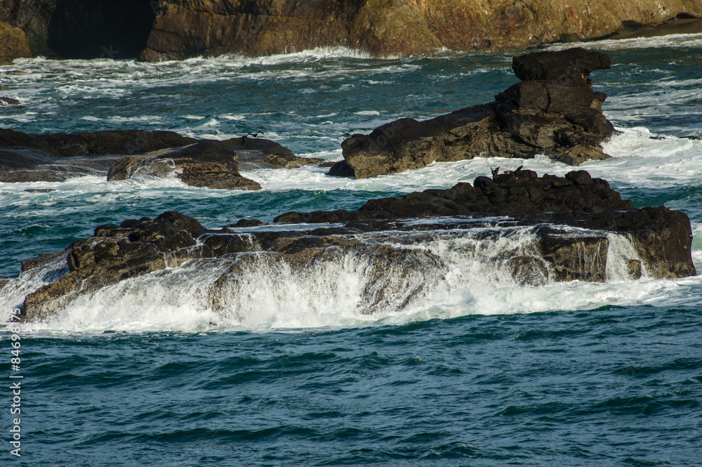 Waves breaking over dark rocks Waves breaking over dark rocks
