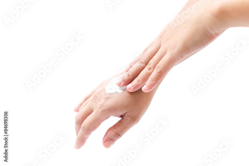 women applying hand cream to hands