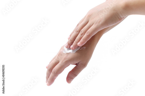 women applying hand cream to hands