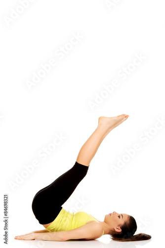 Fitness woman with her legs up.