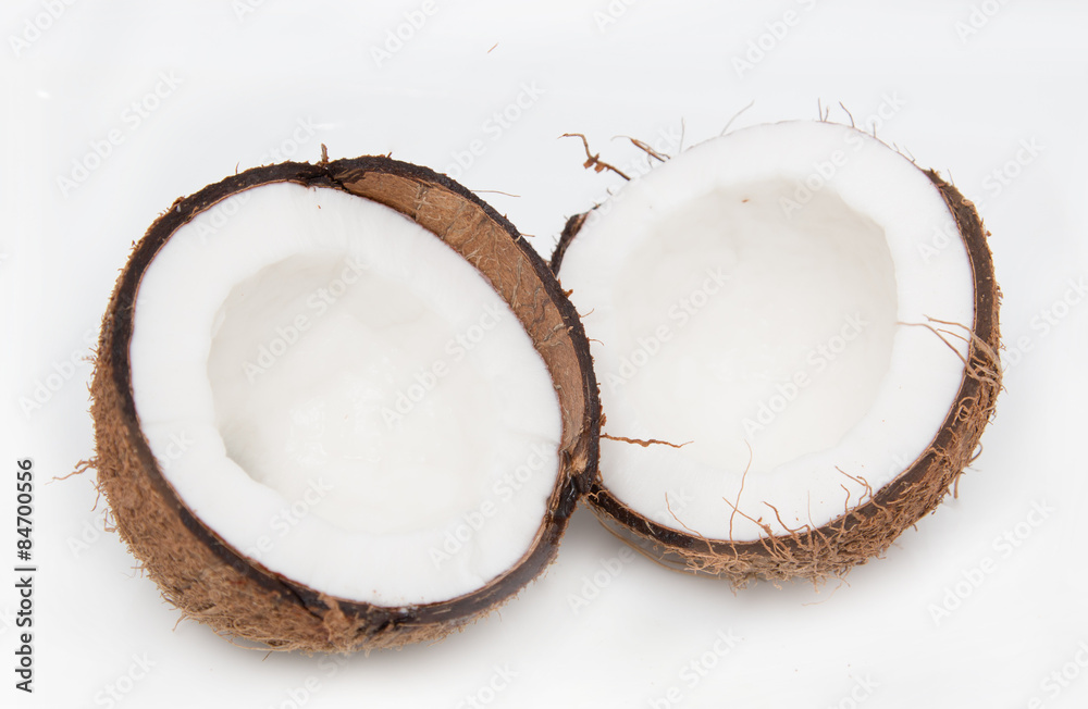 halves of coconut on white background halves of coconut on white background
