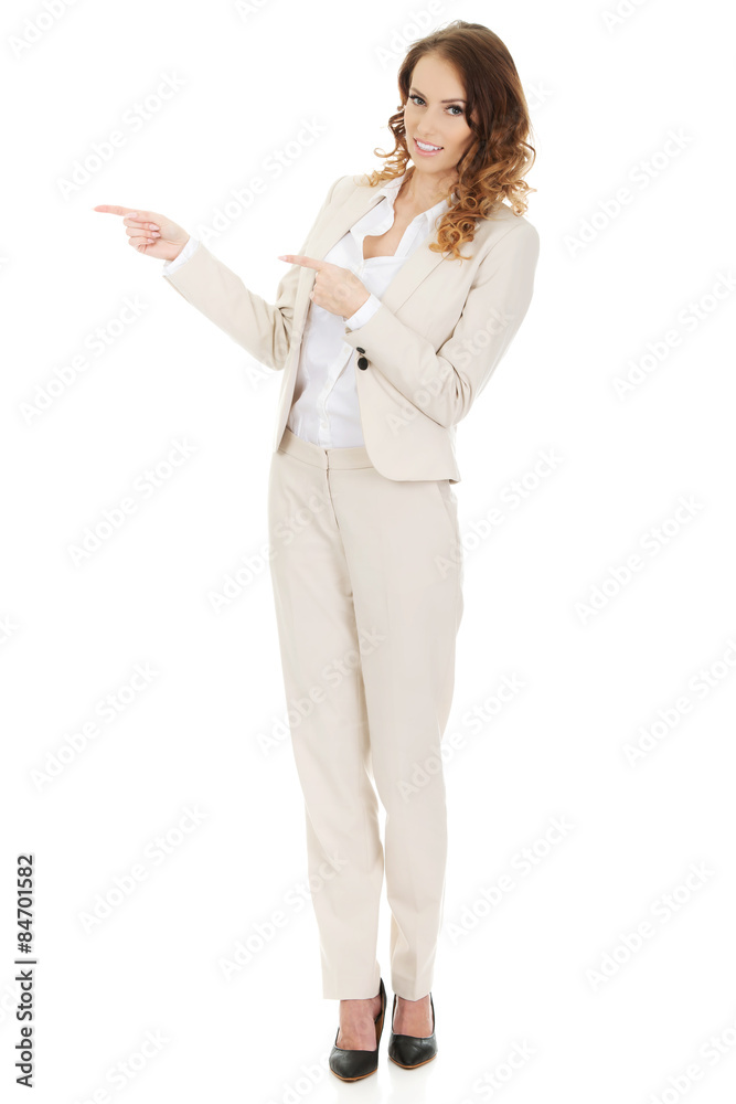 Businesswoman pointing aside. Businesswoman pointing aside.