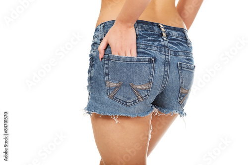 Shirtless woman in jeans shorts.