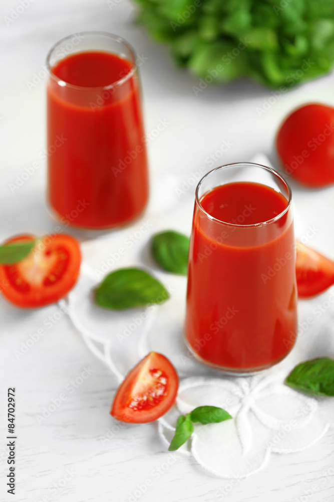 Tomato juice and fresh tomatoes on wooden table close-up Tomato juice and fresh tomatoes on wooden table close-up