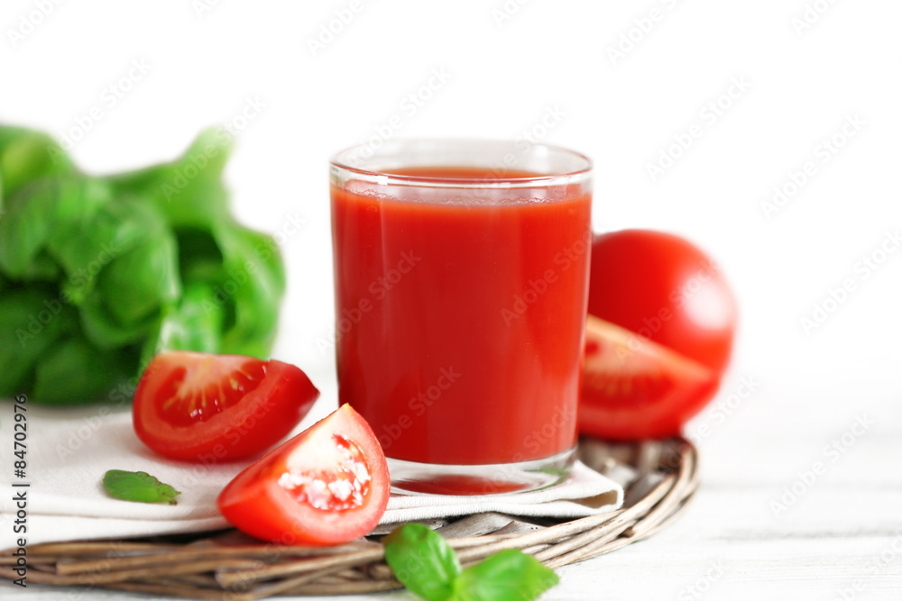 Tomato juice and fresh tomatoes on wooden table close-up Tomato juice and fresh tomatoes on wooden table close-up