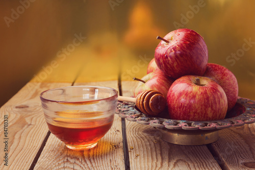 Apple and honey over golden background. Jewish Rosh hashana (new year) celebration