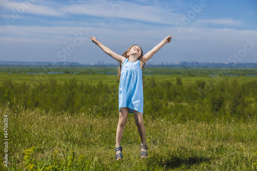  Baby girl jumping on a meadow