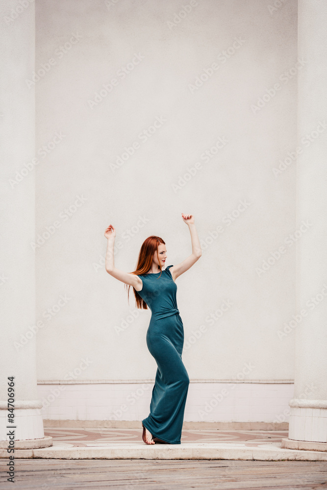 Outdoor portrait of beautiful redhead young woman