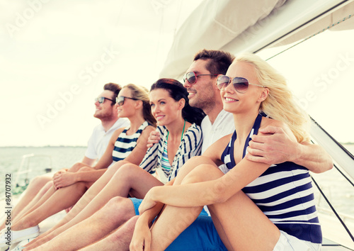 smiling friends sitting on yacht deck © Syda Productions