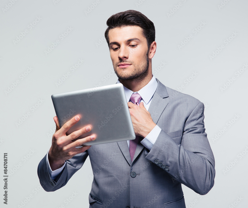 Handsome businessman straightening his tie Handsome businessman straightening his tie