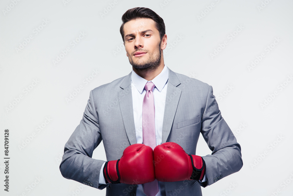 Businessman standing with boxing gloves Businessman standing with boxing gloves