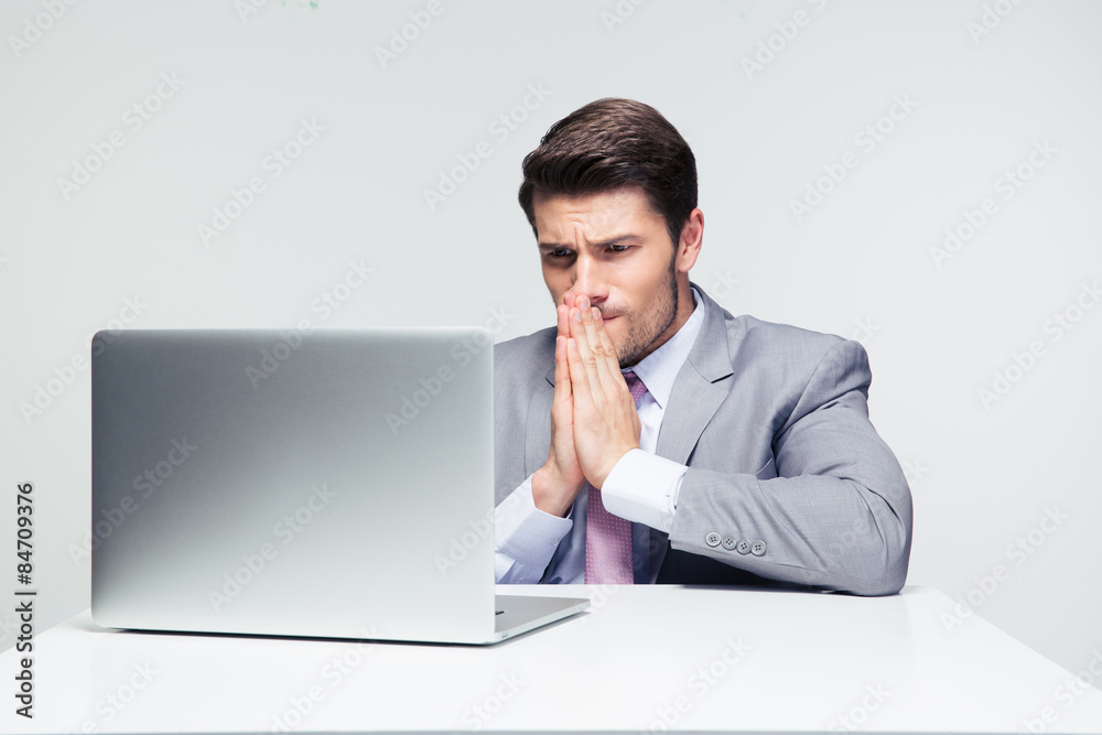 Businessman sitting at the table and praying Businessman sitting at the table and praying