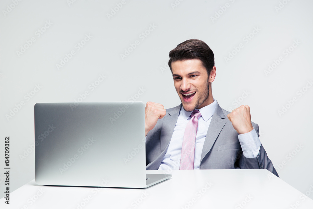 Successful happy businessman looking at laptop Successful happy businessman looking at laptop