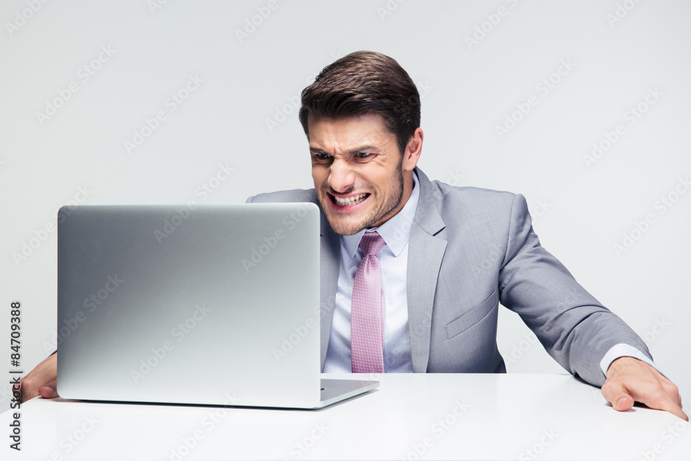 Worried businessman looking at laptop Worried businessman looking at laptop
