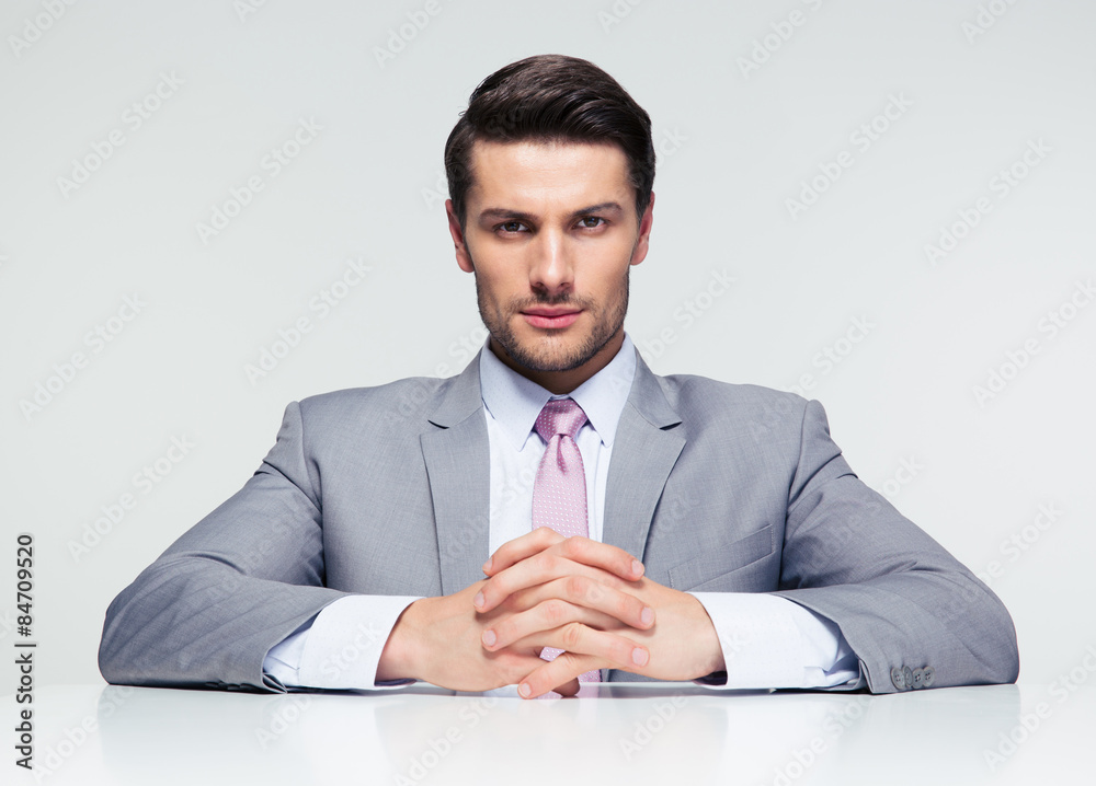 Confident businessman sitting at the table