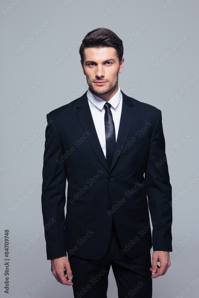 Handsome young businessman looking at camera