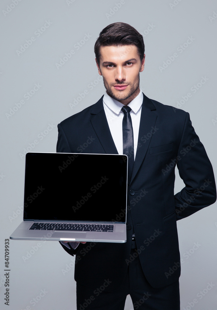 Businessman showing blank laptop screen Businessman showing blank laptop screen