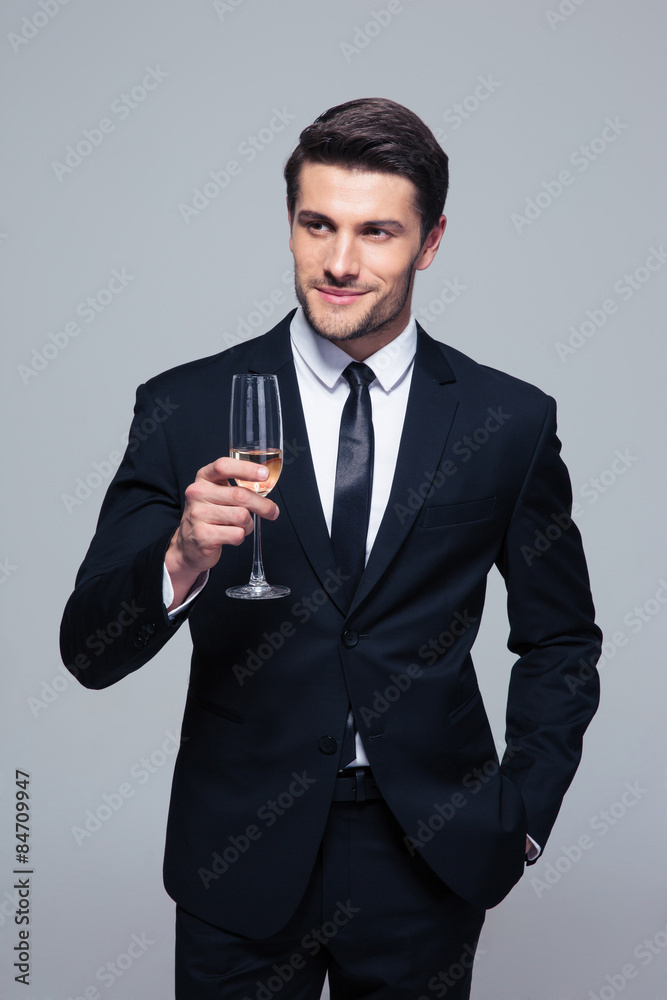 Happy businessman holding glass of champagne Happy businessman holding glass of champagne