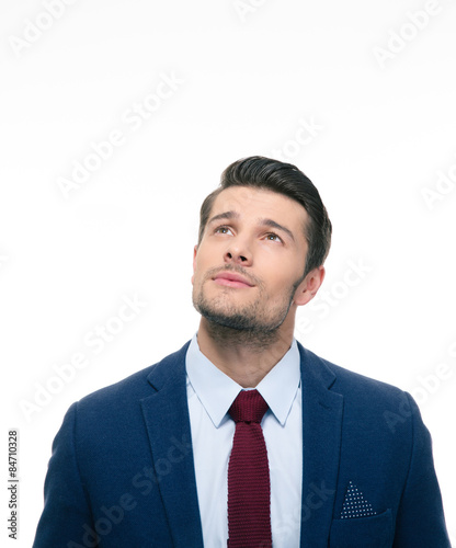 Pensive businessman looking up at copyspace