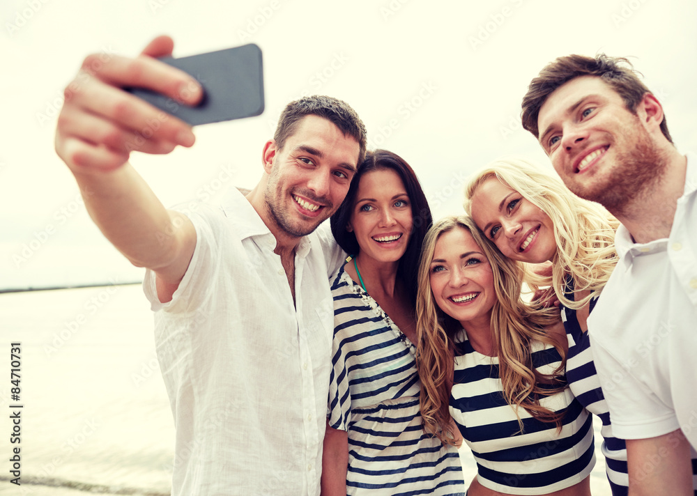 happy friends on beach and taking selfie happy friends on beach and taking selfie