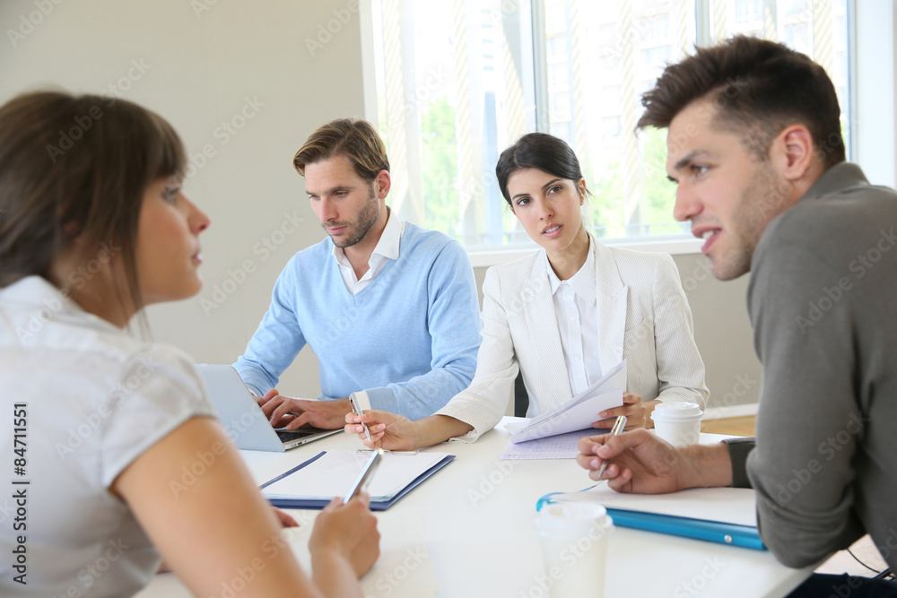 Business people meeting around table in modern space Business people meeting around table in modern space