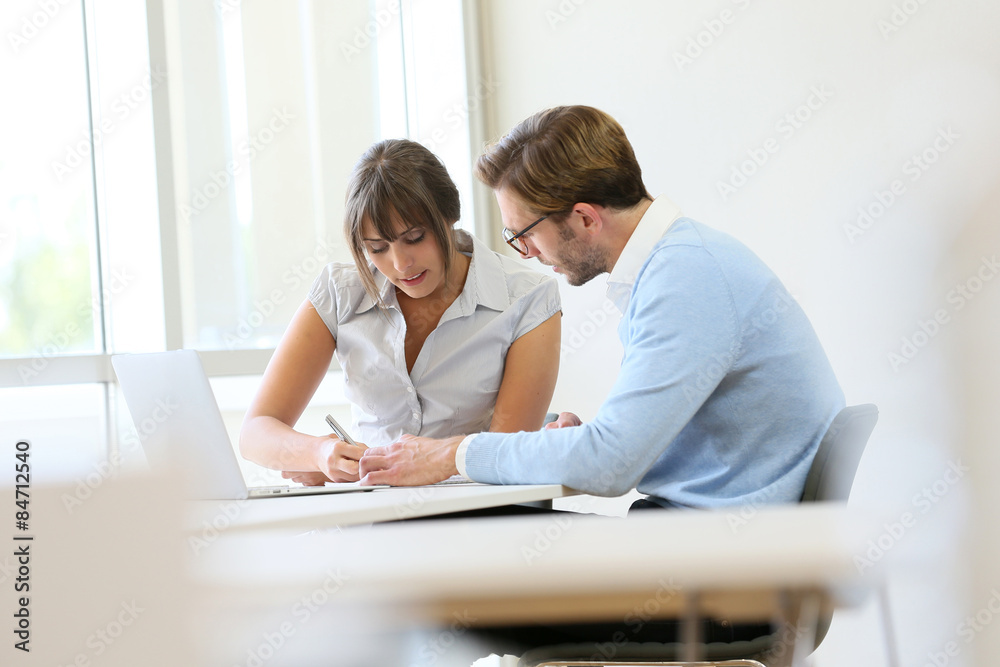 Colleagues working in modern office with laptop Colleagues working in modern office with laptop