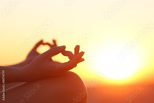 Obraz na plátne Woman hands exercising yoga at sunset
