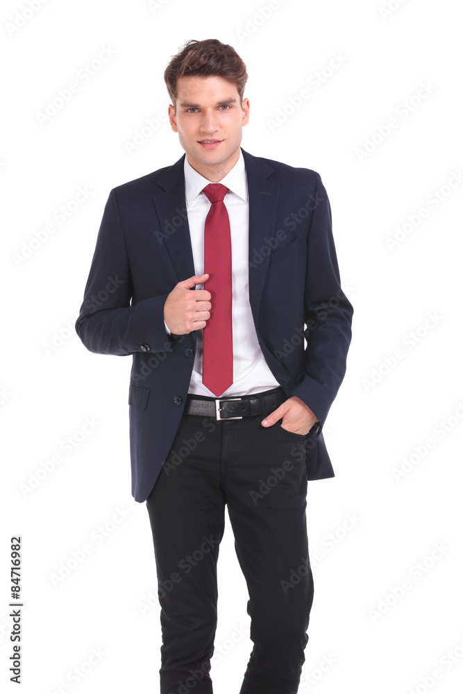 young business man holding his hand in pocket. young business man holding his hand in pocket.