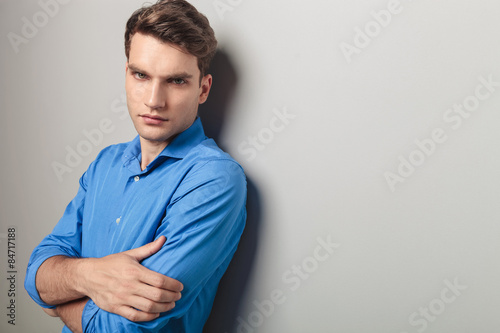 young man holding his hands crossed.