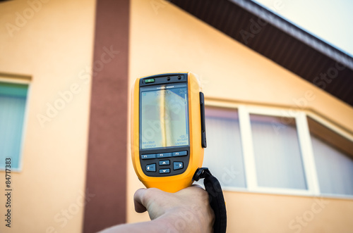 Infrared inspection of window and roof of house. Thermal imaging