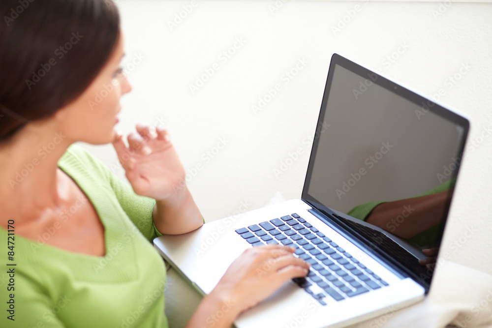 Caucasian woman using a laptop indoors Caucasian woman using a laptop indoors