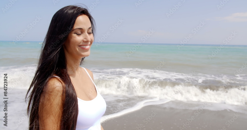Brunette Woman on Beach Smiling Over Shoulder Brunette Woman on Beach Smiling Over Shoulder
