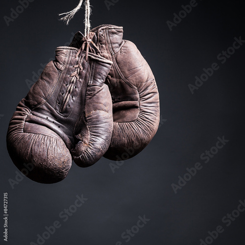 vintage boxing gloves on a black background © BortN66