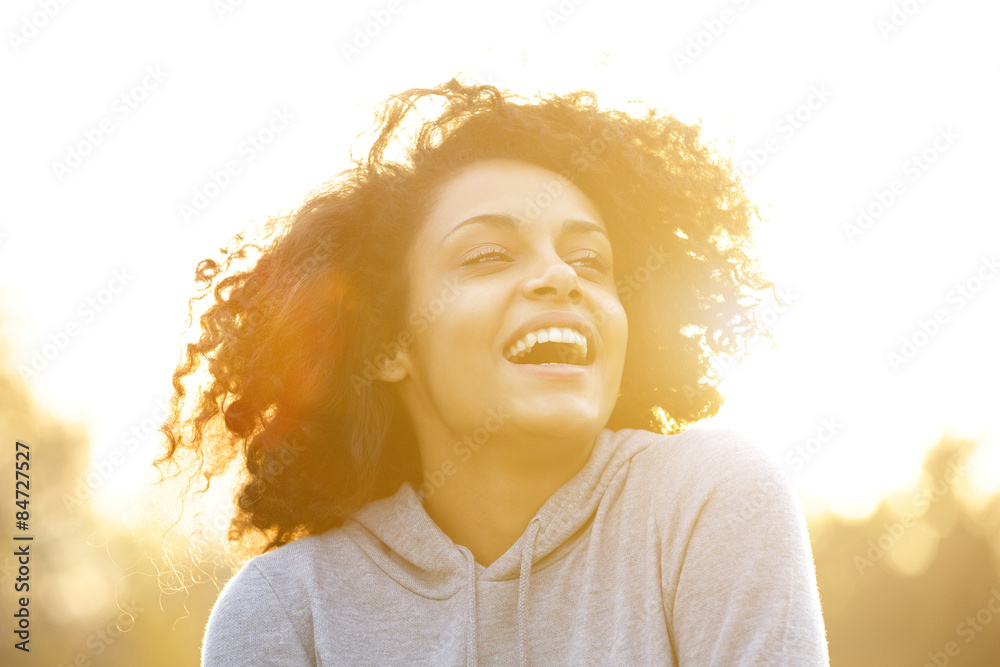 Naklejka premium Happy african american girl laughing outdoors