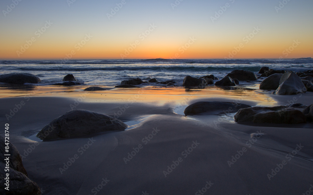 Orange Sky Sunset on a Deserted Rocky Beach