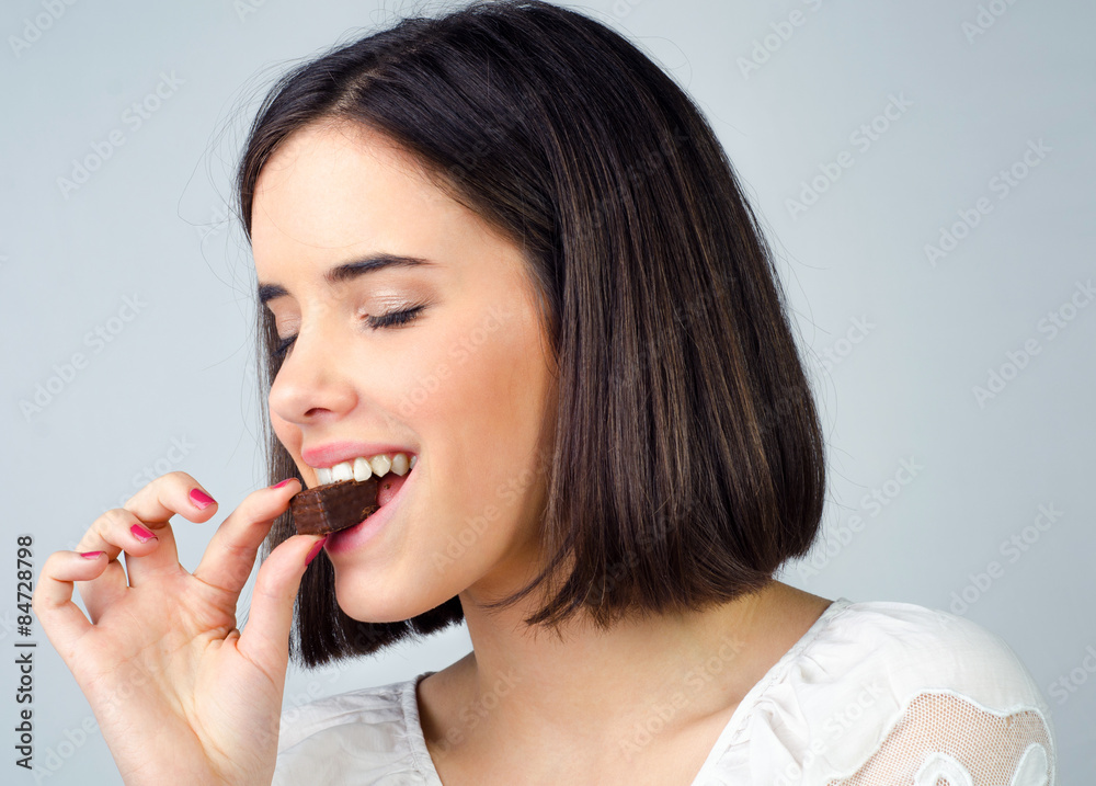 Portrait of the beautiful girl eating chocolate cookies isolated Portrait of the beautiful girl eating chocolate cookies isolated