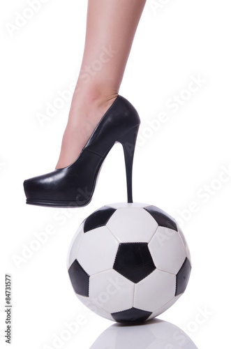 Woman leg with football isolated on white