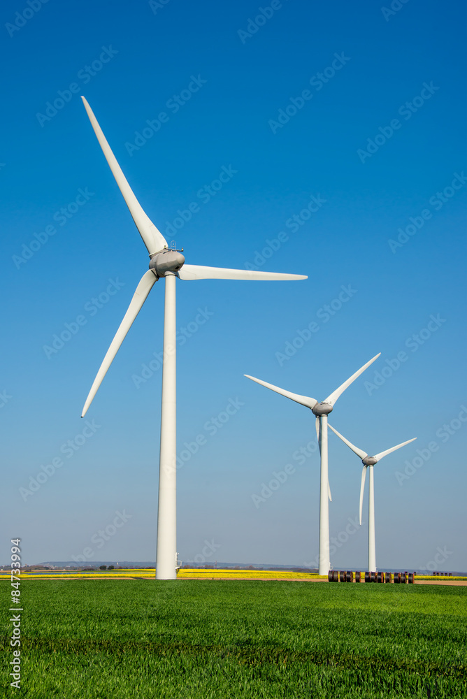 Row of wind turbines in a field Row of wind turbines in a field