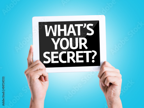 Tablet pc with text Whats Your Secret? with blue background