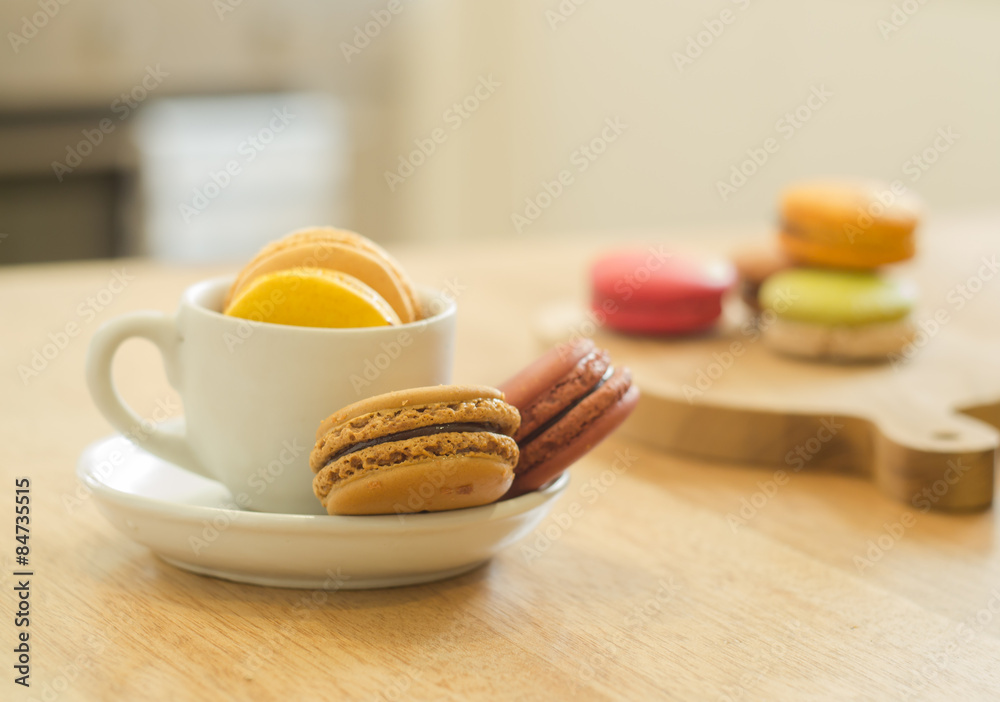 French macarons on wooden table in a kitchen French macarons on wooden table in a kitchen