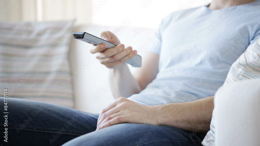 close up of man with beer and remote at home close up of man with beer and remote at home