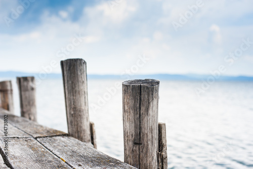 Wooden jetty stake in autumn day