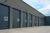 Row of gray numbered business units or garages